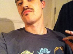 Ali rocking the mo and the tee!
